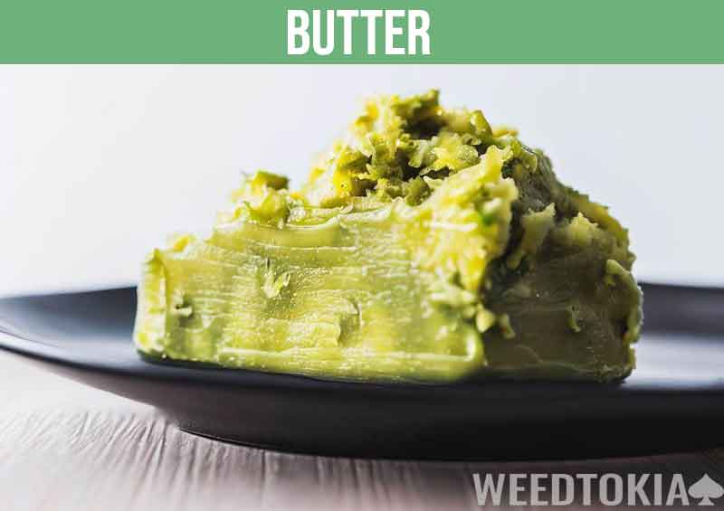 Cannabis butter on a shiny black plate