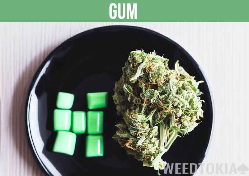 Cannabis chewing gum on table with bud