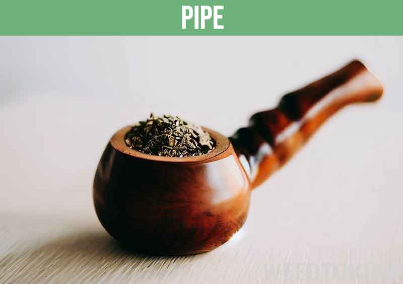Smoking pipe stuffed with cannabis